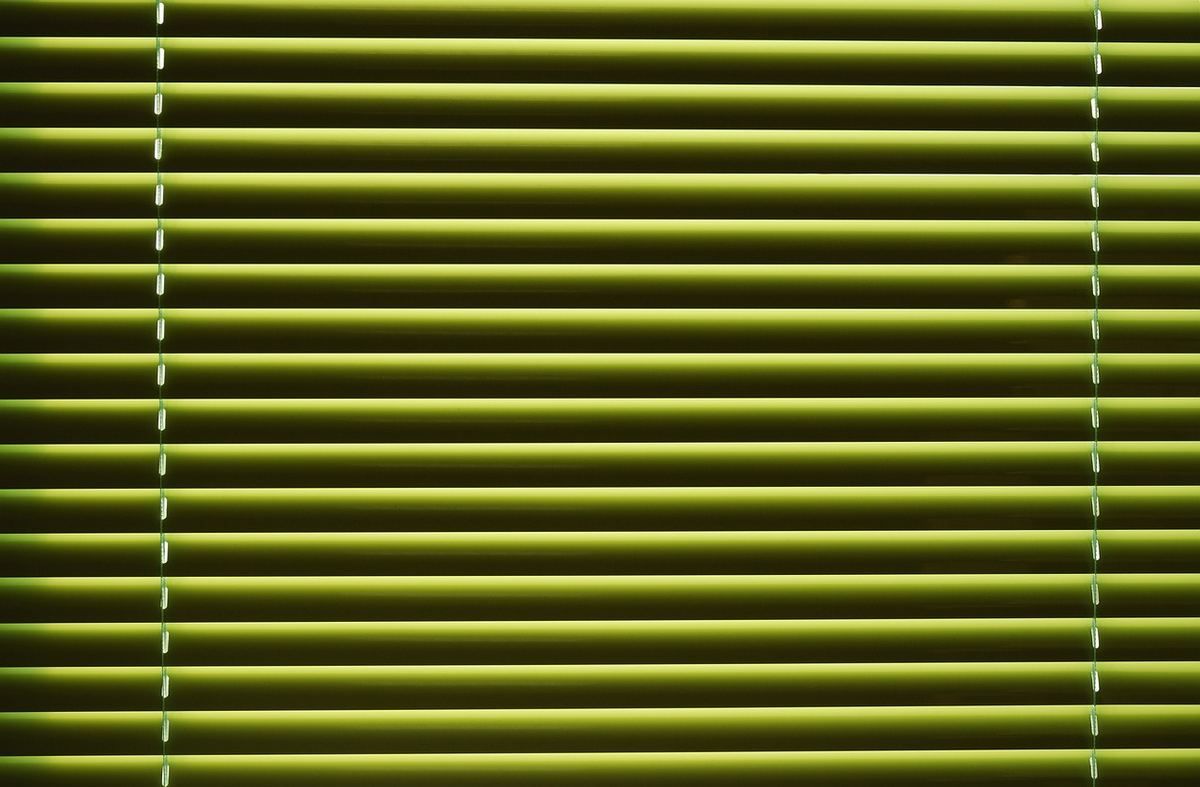 Lames vertes horizontales d'un store vues de face sans ouverture