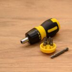 Perceuse sans fil noire et jaune avec bits de visserie sur bois